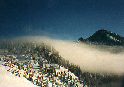 Morning mist pouring over saddle between Chair and Snoqualmie Peaks